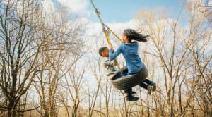 boy and girl on swing